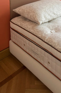 Luxury handmade mattress and pillow with botanical fabric design on wooden floor