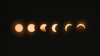 phases of a solar eclipse in a dark sky, glowing crescent shapes in sequence
