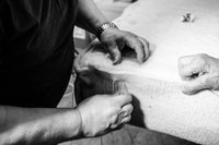 Artisan hand-stitching a luxury mattress with natural materials, close-up view