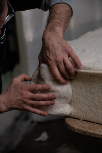 Artisan handcrafting luxury mattress with natural materials for Italian bed