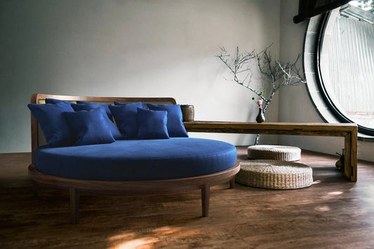 Round blue velvet daybed with wooden frame in modern minimalist living room