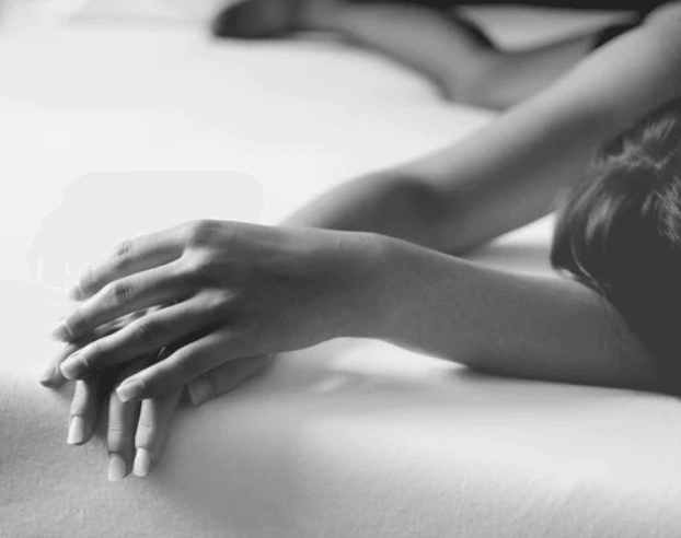 Woman relaxing on a luxury mattress, close-up of hands on soft bedding, natural comfort