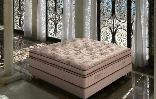 Luxury handmade mattress with floral pattern in sunlit elegant room with ornate iron doors