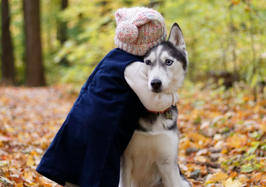 Baby hugging a dog