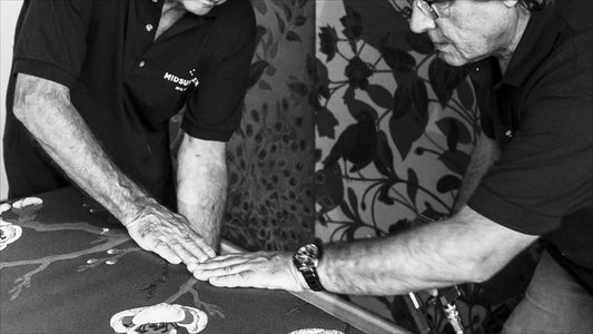 Artisans handcrafting luxury bed upholstery with floral detail, Italian design craftsmanship