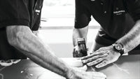 Artisans handcrafting a luxury mattress with natural materials in a workshop