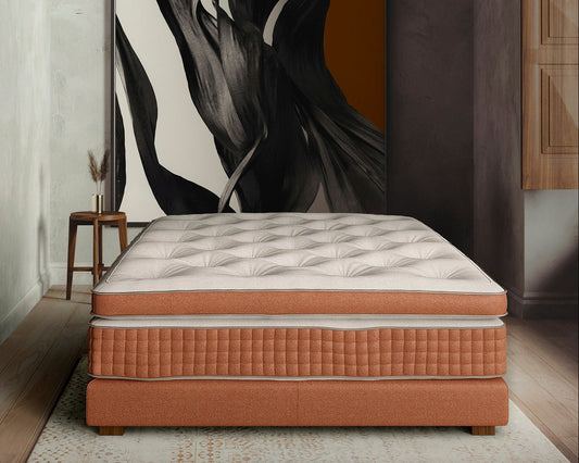 Luxury handmade mattress with bicolor white and orange cover in modern bedroom setting