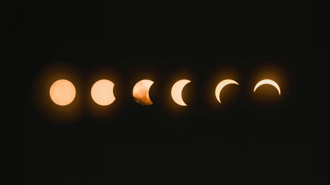 phases of a solar eclipse in a dark sky, glowing crescent shapes in sequence