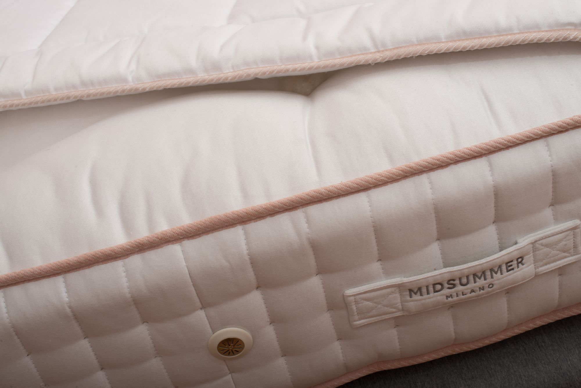 The Midsummer Milano label on a mattress border