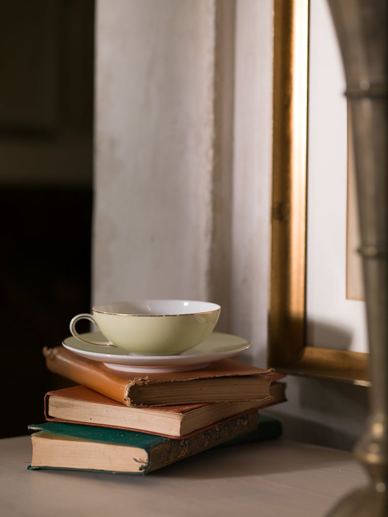 Tea and a book on the windowsill.